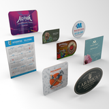 A collection of postcard magnets in different shapes, including an oval shape.